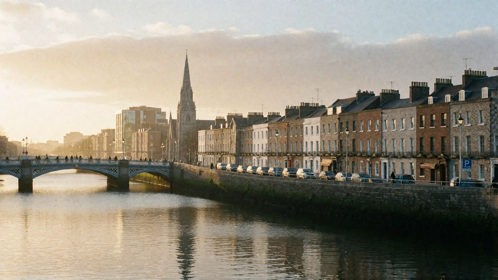 Golden-hour view along the River Liffey in Dublin with Georgian quays and cast-iron bridges